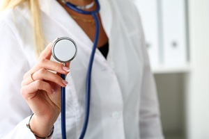 female doctor holding stethoscope
