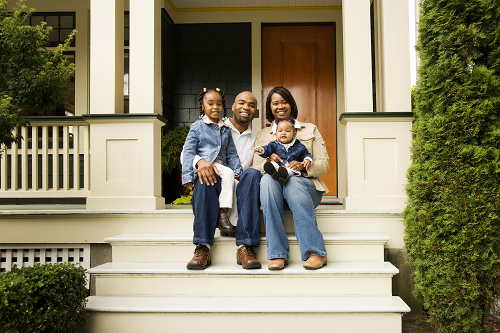 a family sitting on a front porch